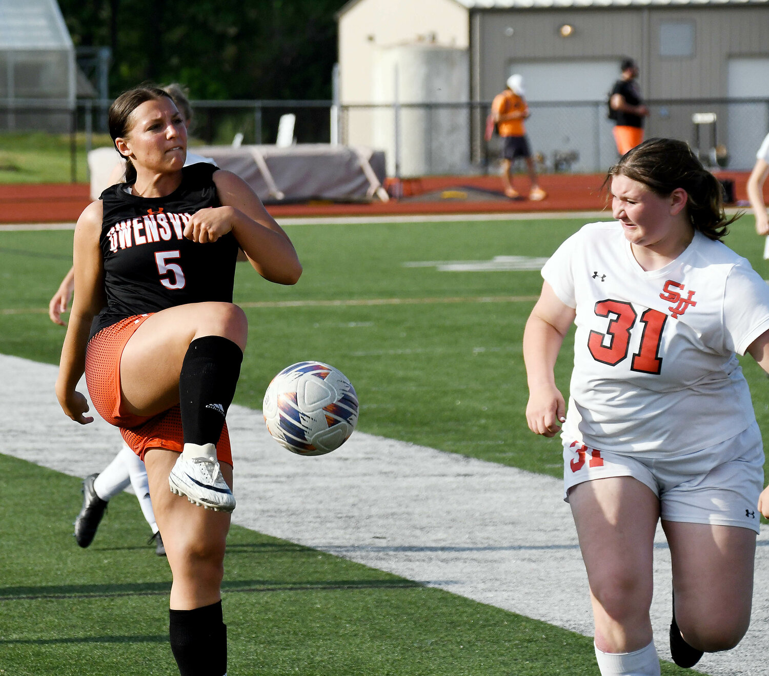 Drew Copeland (left) sends the ball up field during Owensville Dutchgirl soccer senior night action Monday at Dutchmen Field while St. James’ Baylee Jones defends for the visiting Lady Tigers. Copeland was one of eight seniors recognized for their contributions to the Dutchgirl soccer program prior to their 4-0 victory over St. James.